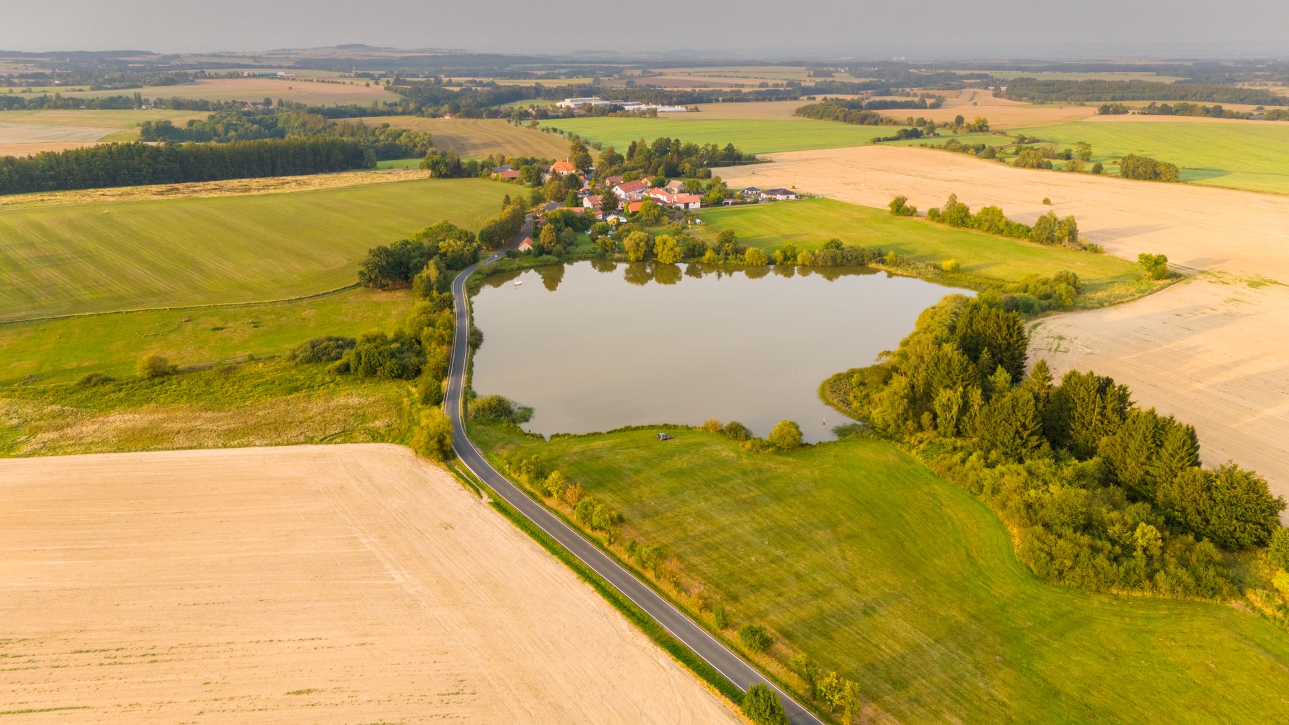 Panorama pól i jeziora na czeskiej wsi w okolicach Zbraslavic